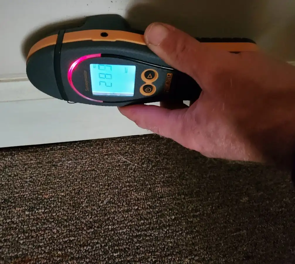 Moisture detection at baseboard during Storm Damage Restoration in Dunkirk